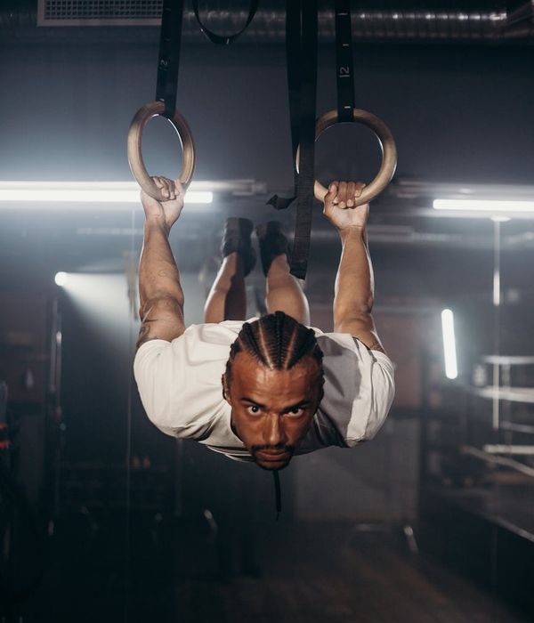 Man focused during a difficult balance and strength exercise.